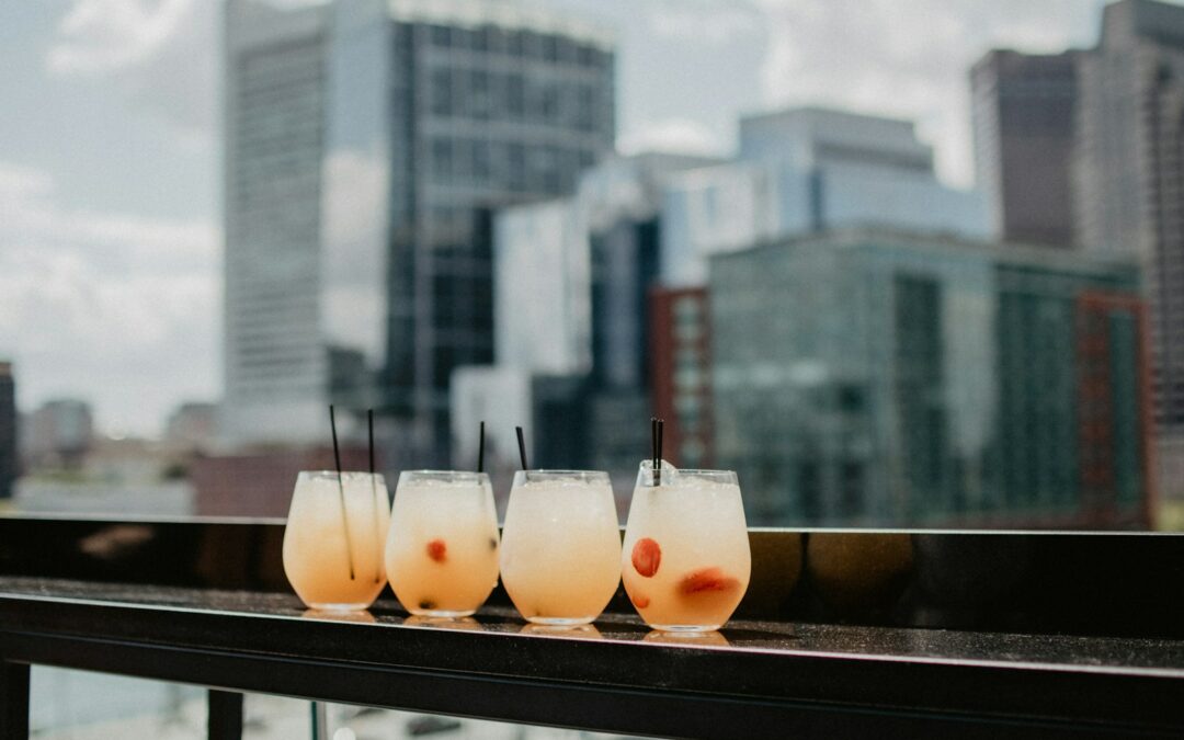 four clear drinking glasses on black surface