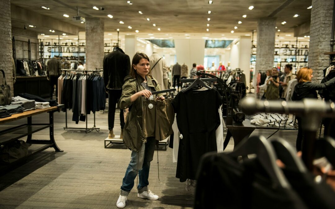 woman holding apparel inside shopping building